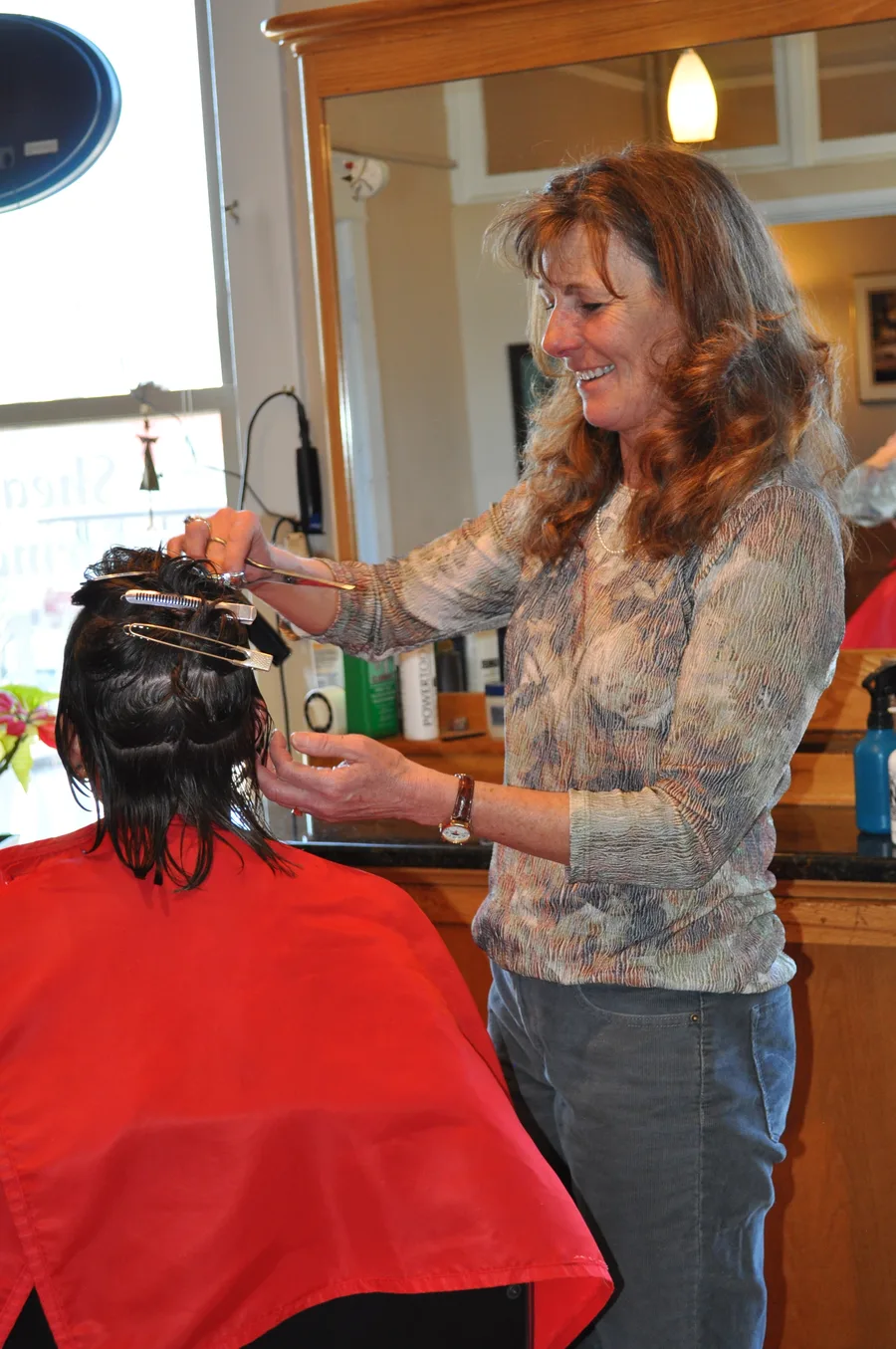 Denyce cutting a client's hair at Shear Performance